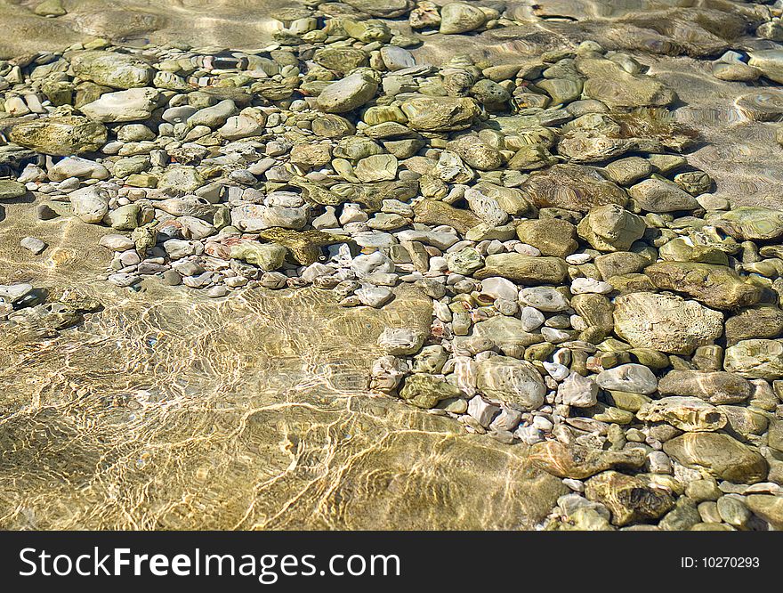 Pebbles under water as background