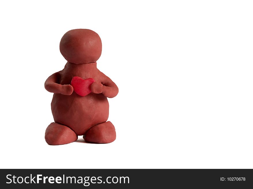 Plasticine man keeping a heart in the hands isolated over white background