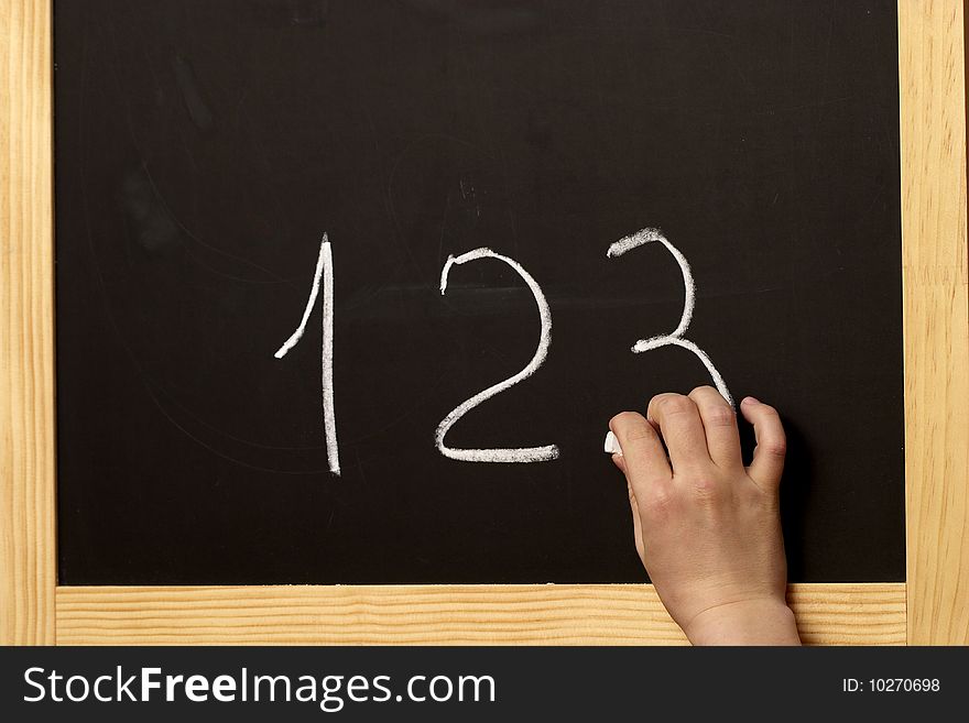 Drawing digits on the blackboard with chalk. Drawing digits on the blackboard with chalk