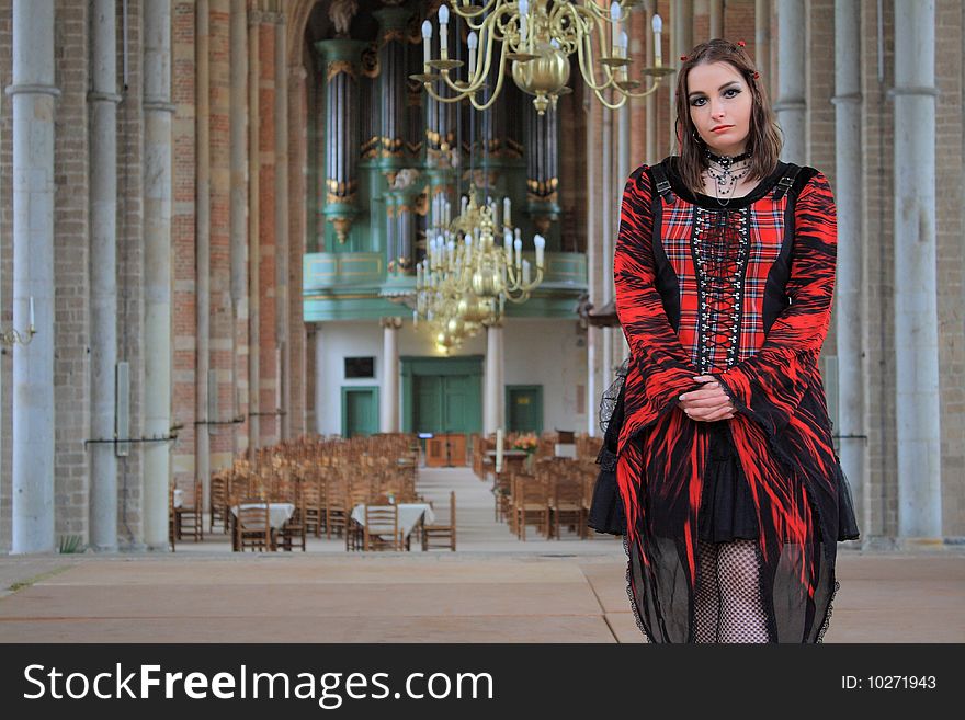 Gothic girl with mini skirt posing inside of a church. Gothic girl with mini skirt posing inside of a church.