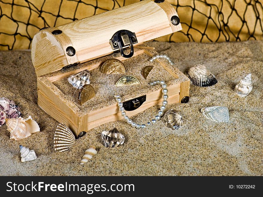 Beads, coins and baubles in a wooden chest. Beads, coins and baubles in a wooden chest.