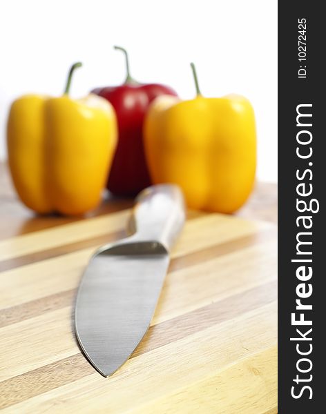 Knife and capsicum on chopping board