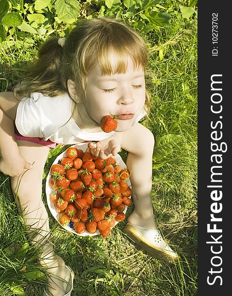 Little Girl eating ripe strawberries. Non-Urban Scene. Little Girl eating ripe strawberries. Non-Urban Scene.