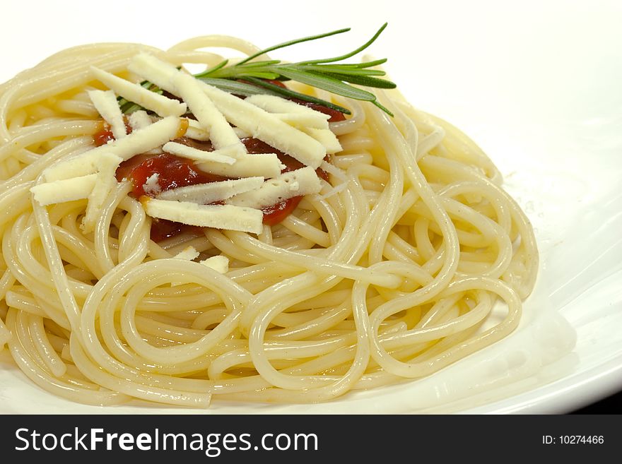 Portion of spaghetti with tomato sauce on a white plate