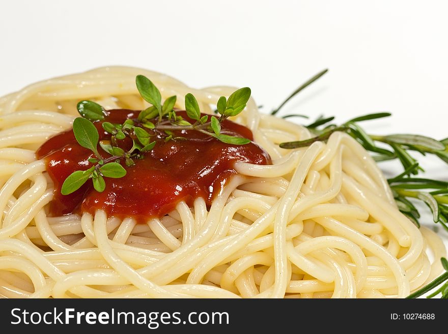 Portion of spaghetti with tomato sauce on a white background