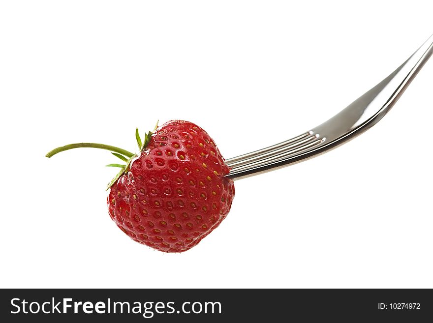 Strawberry on a fork on white background