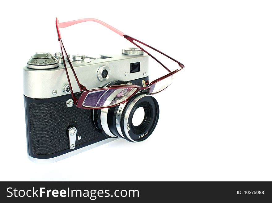 Vintage camera with eyeglasses on lens isolated on white. Vintage camera with eyeglasses on lens isolated on white.