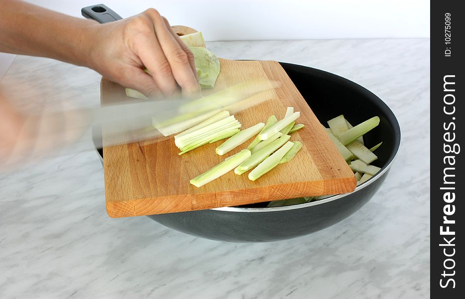 Housewife cutting fresh vegetable in the kitchen isolated. Housewife cutting fresh vegetable in the kitchen isolated.