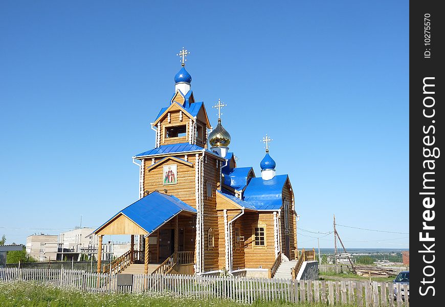 New wooden Orthodox temple (church) with blue roofs. New wooden Orthodox temple (church) with blue roofs.