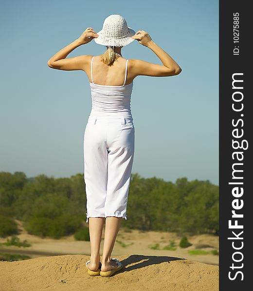 The young woman in white clothes on rest in the summer on the nature