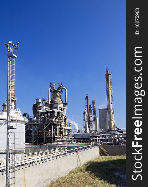 Oil refinery in Italy with tall smokestacks. Oil refinery in Italy with tall smokestacks