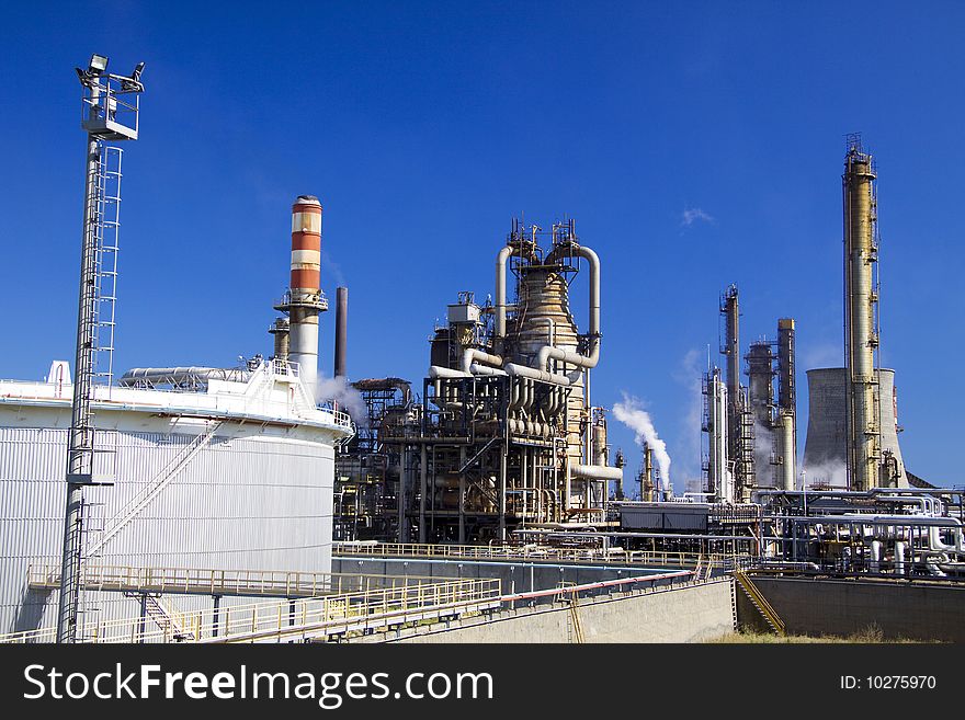 Oil refinery in Italy with tall smokestacks. Oil refinery in Italy with tall smokestacks
