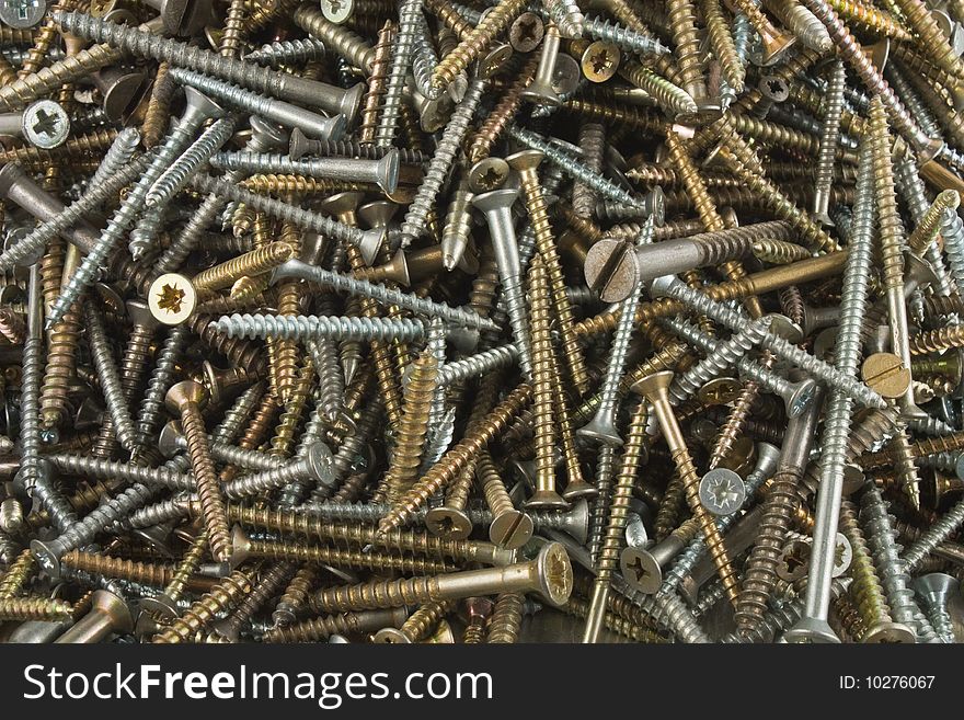 Texture of different screws in white and yellow metal