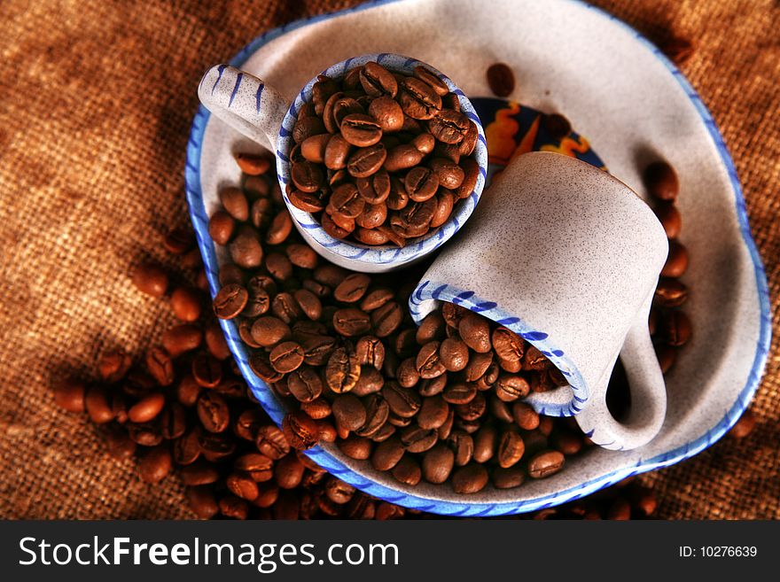 Cup, dish and beans of coffee. Cup, dish and beans of coffee