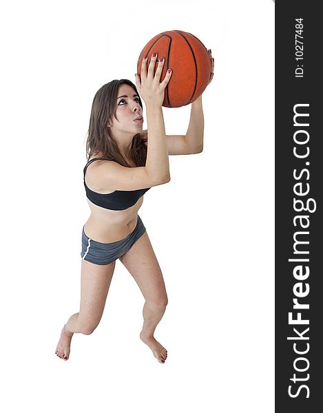 Young cute woman playing basketball