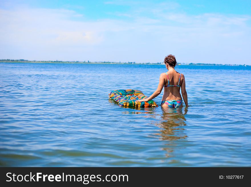 Girl swin in the ocean on air bed. Girl swin in the ocean on air bed