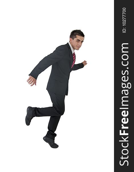 An young businessman in running position. An young businessman in running position