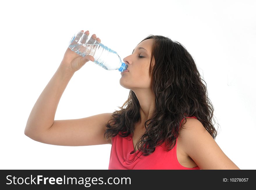 Young woman drinks water from a bottle.