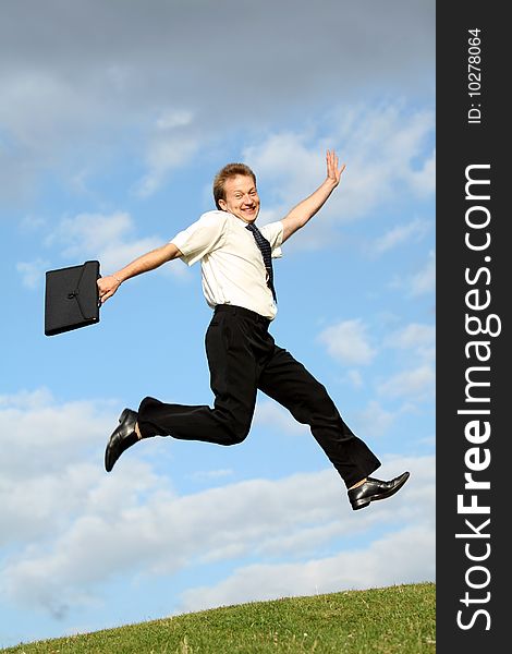 Happy businessman with bag jumps in the air. Happy businessman with bag jumps in the air