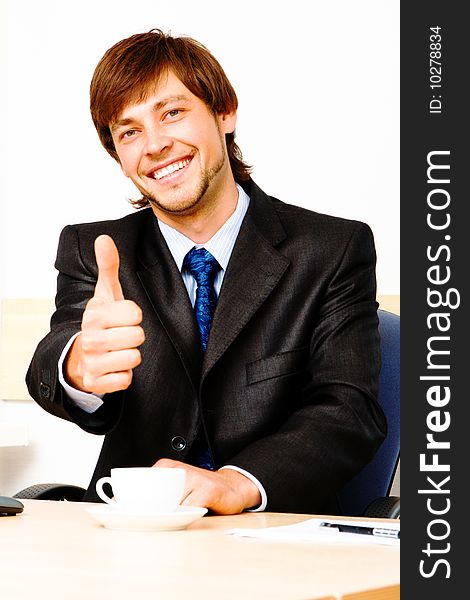 Successful businessman showing thumbs up. Successful businessman showing thumbs up