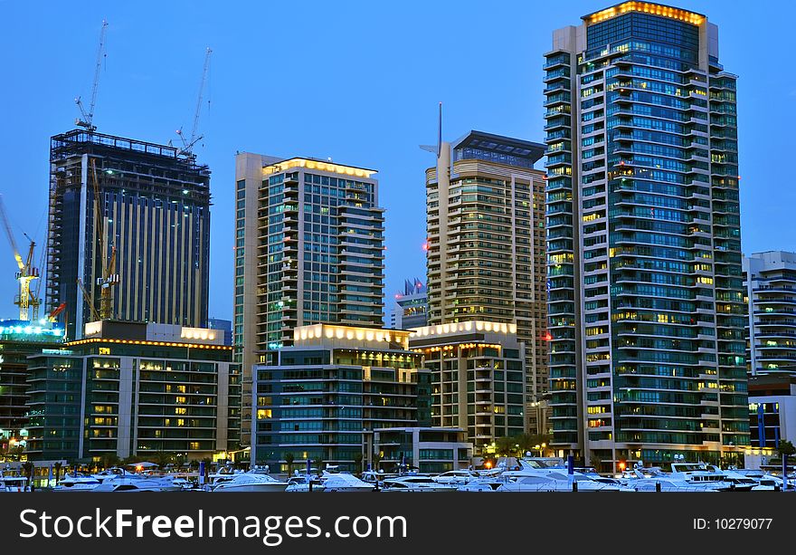 Luxury Yachts in Dubai Marina with waterfront Apartments in the background. Luxury Yachts in Dubai Marina with waterfront Apartments in the background