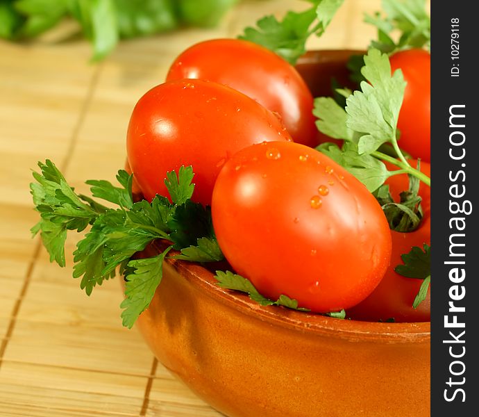 Tomatoes and parsley in bowl. Vegetables ingredient.