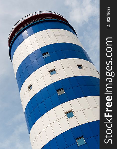 A blue and white striped potable water storage tower. A blue and white striped potable water storage tower