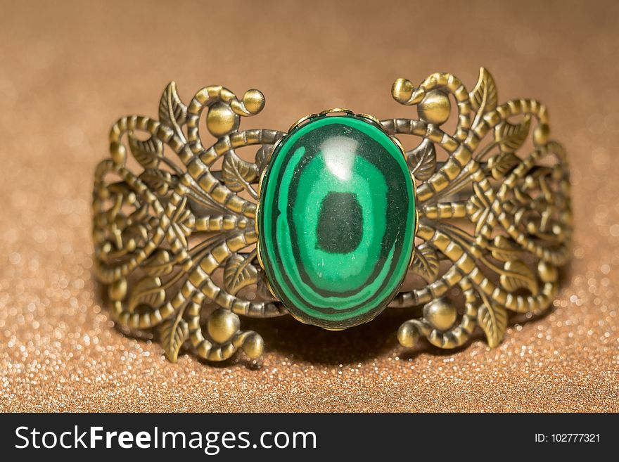Vintage ornamental bronze bracelet with big green stone malachite imitation. Vintage ornamental bronze bracelet with big green stone malachite imitation.