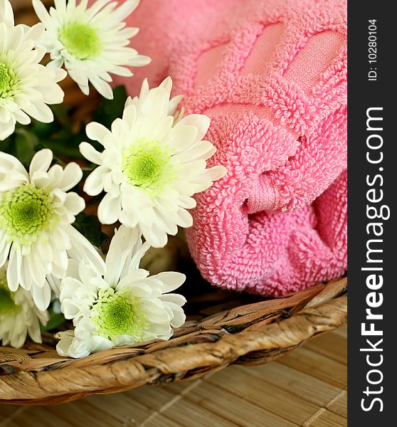 Pink towel and white flowers - beauty treatment. Pink towel and white flowers - beauty treatment.