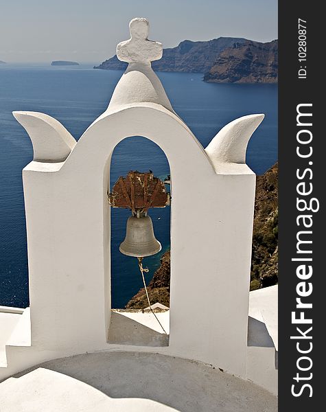 An old bell with a view of the ocean from Santorini, greece