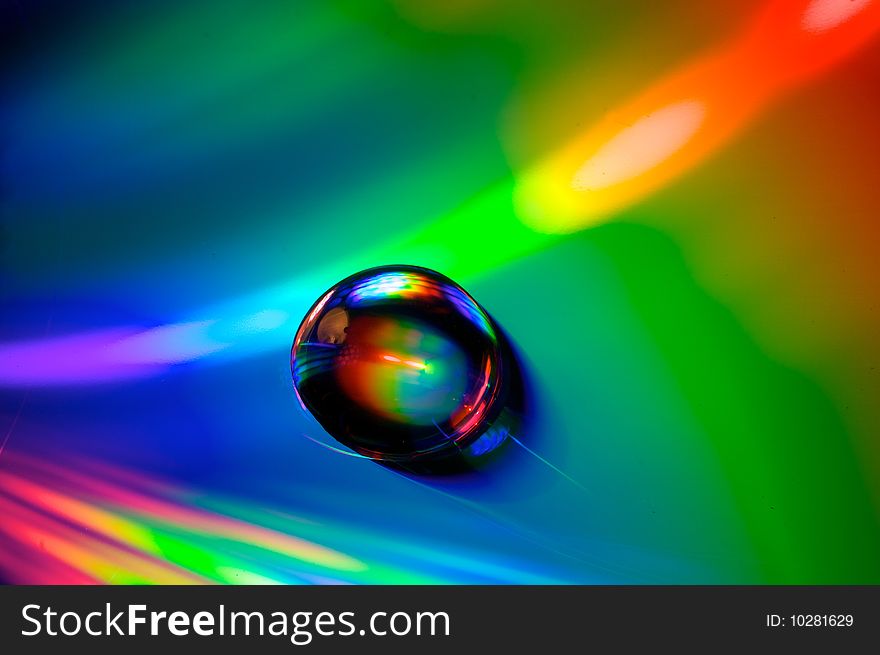A water droplet on a compact disk. A water droplet on a compact disk
