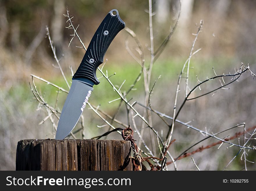 Knife on a wooden post. Knife on a wooden post