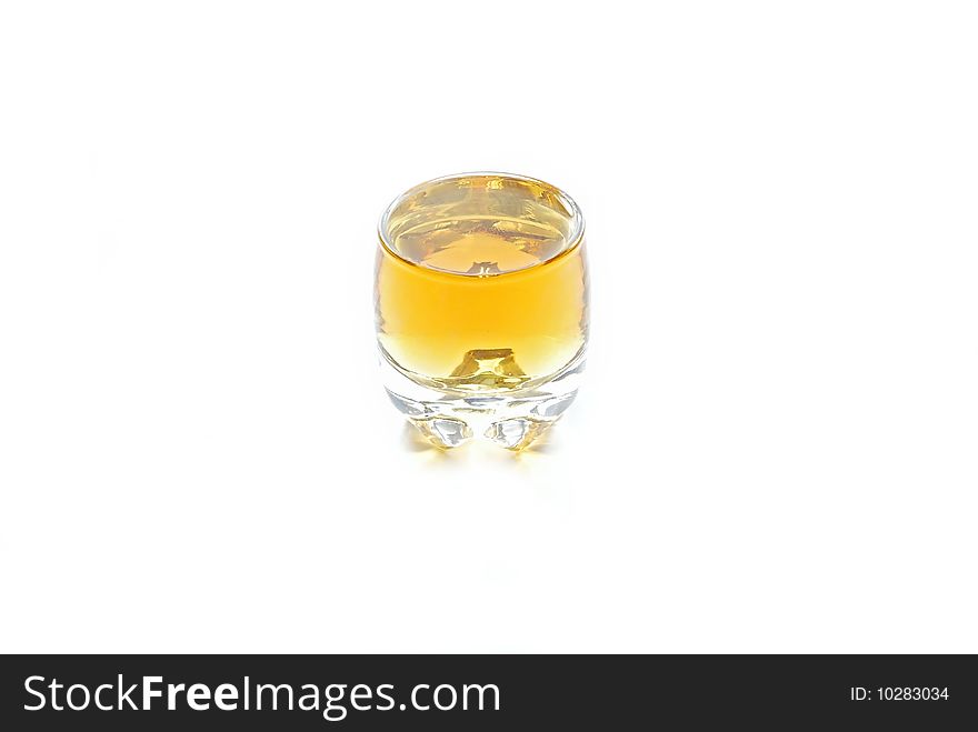 A shot of whiskey over white. A shot of whiskey over white