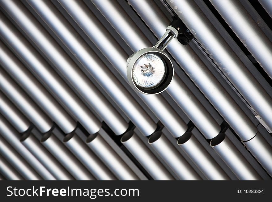 Spot Light suspended from a modern tubular steel ceiling.