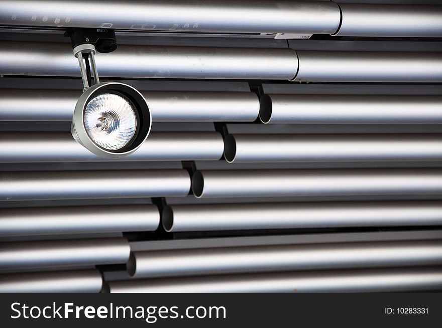 Spot Light suspended from a modern tubular steel ceiling.