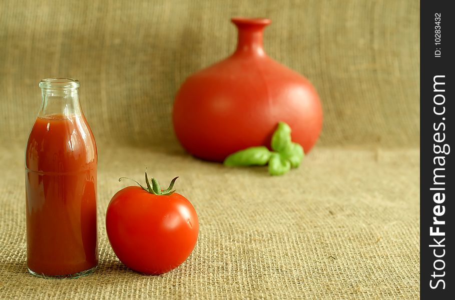 Tomato juice and tomato on beige background. Tomato juice and tomato on beige background