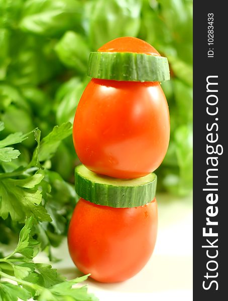 Tomatoes and cucumbers on a white background