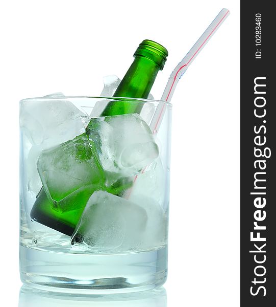 Cocktail: glass with ice and green bottle. Cocktail: glass with ice and green bottle