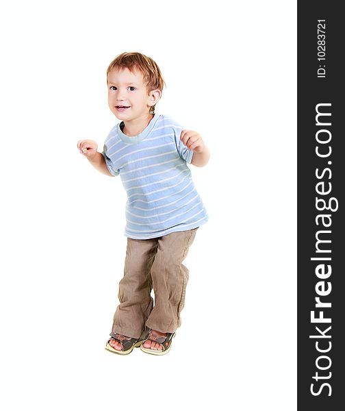 Happy young boy jumping over white