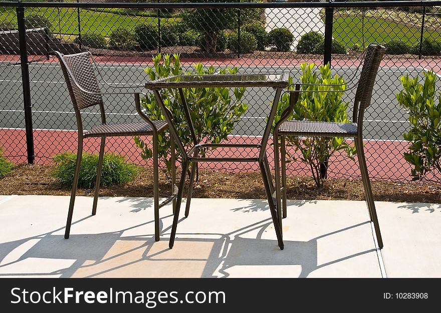 A table for 2 beside the tennis court. A table for 2 beside the tennis court.