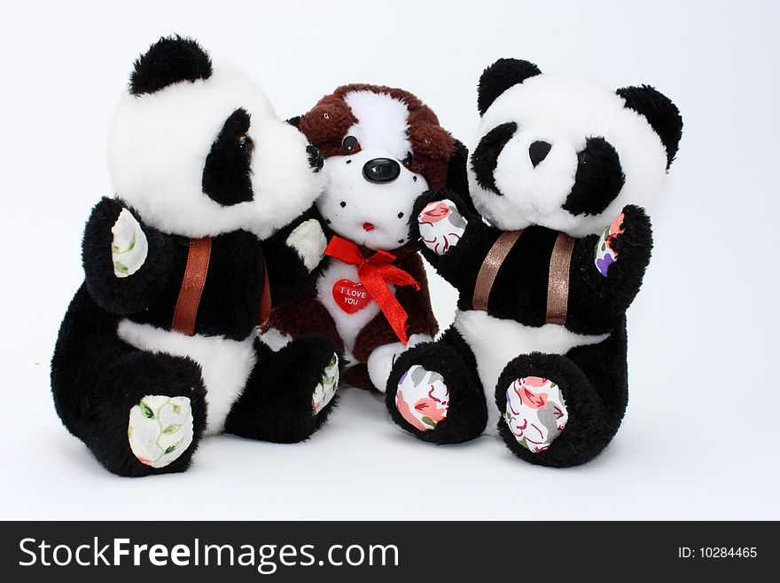 Two pandas and a dog, child toys of plush, isolated