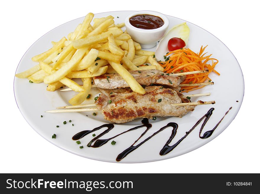 Meat skewers with fries and a little sauce