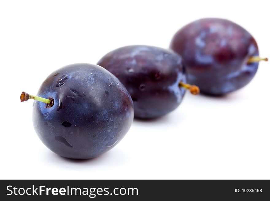 Plums On A White Plate