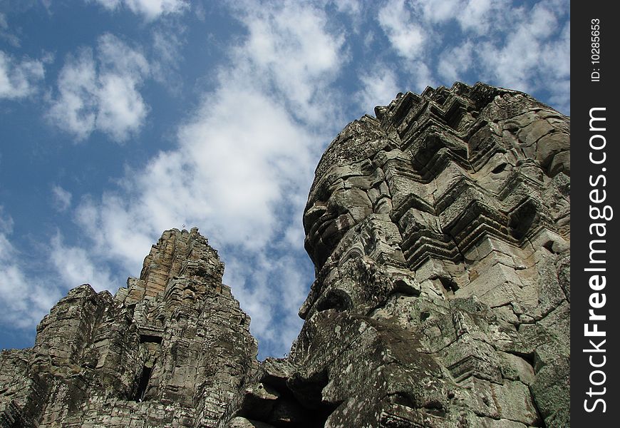 Photo of an iconic face on the bayon temple near siem reap, cambodia. Photo of an iconic face on the bayon temple near siem reap, cambodia.