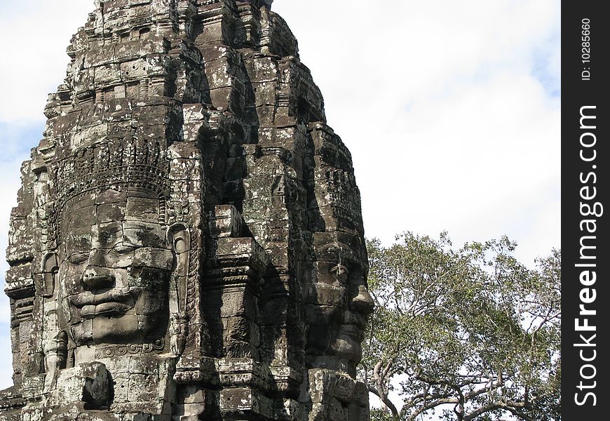 Photo of an iconic face on the bayon temple near siem reap, cambodia. Photo of an iconic face on the bayon temple near siem reap, cambodia.