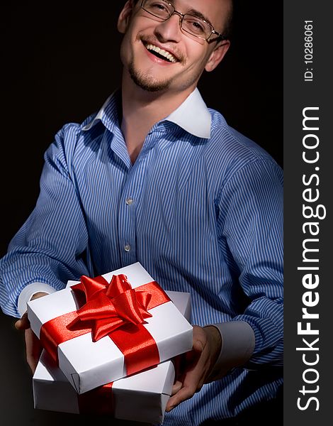 Smiling man holding fine wrapped gift box