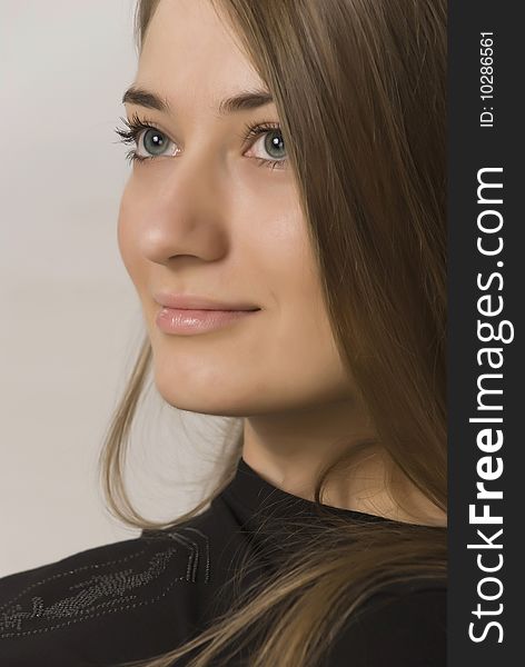 Young sexual girl blonde portrait in a studio on a grey   background