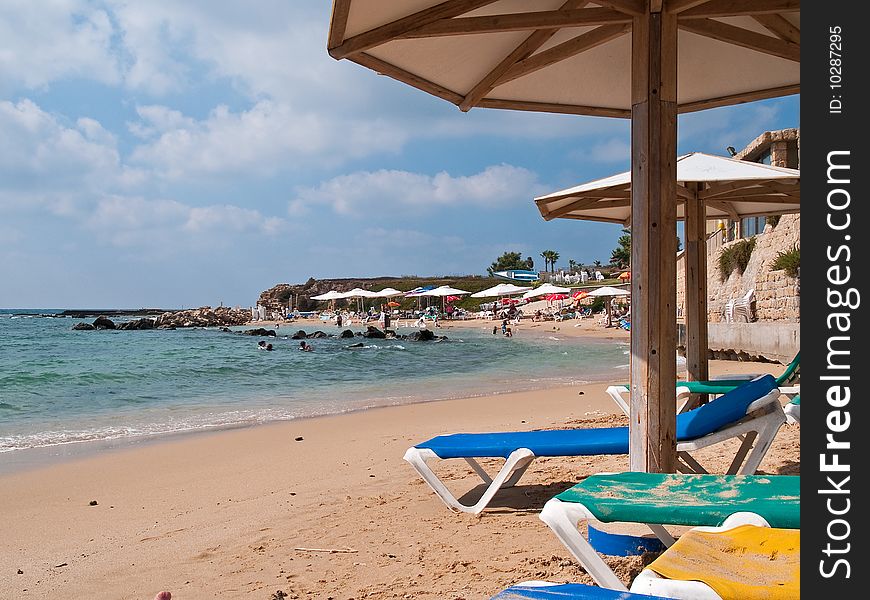 Summer vacation beach resort with umbrellas and colorful chairs