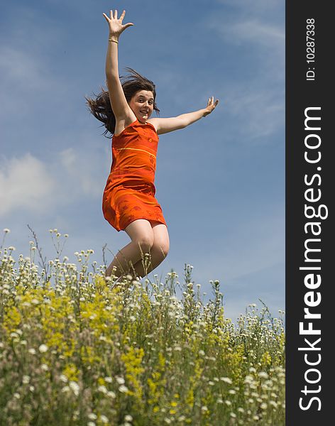 Jumping girl on the green hill (summer)