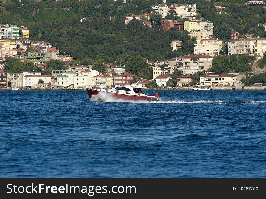 Classical powerboat passing through Straits of Bhosporus. Istanbul. Turkey